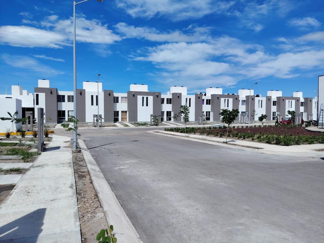 Calle de casas de Tres Lunas con jardineras al frente
